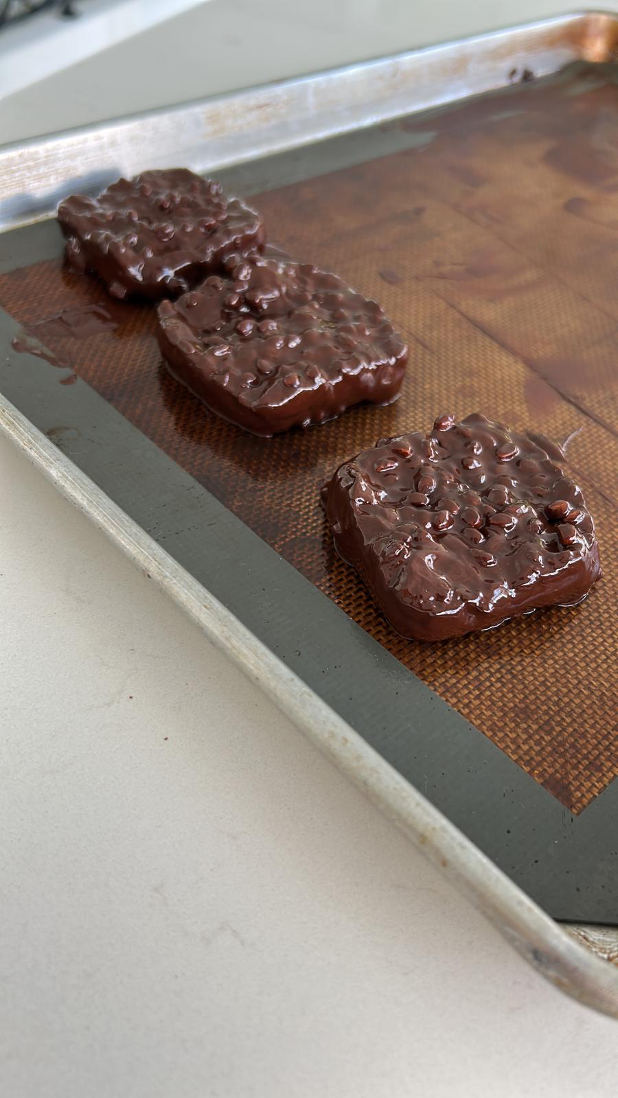 Real square Gut Freak chocolate bars cooling on a tray
